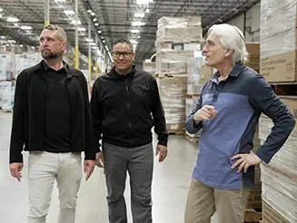3PL logistics owners Bill Drummer and Brian Cantrell touring a GPA warehouse with a colleague.